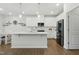 Spacious kitchen with modern appliances, white cabinets, and a large island with sink at 1112 Prewitt Ranch Dr, Holly Springs, NC 27540
