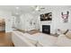 Spacious living room featuring a fireplace, TV, and a cozy sectional couch for comfortable lounging at 1112 Prewitt Ranch Dr, Holly Springs, NC 27540
