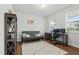 Bright office with a neutral color scheme, featuring a gray futon and a workstation with dual monitors at 1112 Prewitt Ranch Dr, Holly Springs, NC 27540