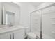 Bright bathroom features a white shower, and a granite countertop with a mirror above the sink at 112 Moonflower Ln # Homesite 267, Wilson's Mills, NC 27520