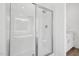 Bathroom features a bright white shower with chrome finishing and a translucent door at 112 Moonflower Ln # Homesite 267, Wilson's Mills, NC 27520