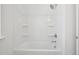 Clean bathroom featuring a bright white shower and tub combo with a shower head and wall shelving at 112 Moonflower Ln # Homesite 267, Wilson's Mills, NC 27520