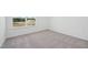 Carpeted bedroom with a large window overlooking a neighborhood and an electrical outlet at 112 Moonflower Ln # Homesite 267, Wilson's Mills, NC 27520