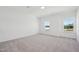 Bright bedroom features plush carpet, two windows, and freshly painted white walls at 112 Moonflower Ln # Homesite 267, Wilson's Mills, NC 27520