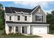 Charming two-story home featuring a gray exterior, black shutters, and a welcoming front porch at 112 Moonflower Ln # Homesite 267, Wilson's Mills, NC 27520
