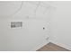 This laundry room boasts sleek white walls, and a convenient wire rack for storage solutions at 112 Moonflower Ln # Homesite 267, Wilson's Mills, NC 27520