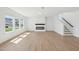 Bright, airy living room with large windows, fireplace, and modern staircase at 112 Moonflower Ln # Homesite 267, Wilson's Mills, NC 27520