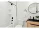 Bathroom featuring a bathtub, black hardware, modern vanity and round mirror at 117 Bertie Dr, Raleigh, NC 27610