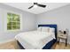 Bedroom featuring a padded blue headboard, ceiling fan and natural light at 117 Bertie Dr, Raleigh, NC 27610
