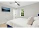 Bright bedroom with ceiling fan, wall-mounted television and natural light at 117 Bertie Dr, Raleigh, NC 27610