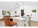 Kitchen island with seating and a view into the adjacent living area at 117 Bertie Dr, Raleigh, NC 27610