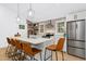 Bright kitchen with a spacious island, white cabinetry, and a stainless steel refrigerator at 117 Bertie Dr, Raleigh, NC 27610