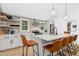 Modern kitchen with a large island, white countertops, and stainless steel appliances at 117 Bertie Dr, Raleigh, NC 27610