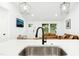 Open concept living area with stainless steel kitchen sink and leather couches at 117 Bertie Dr, Raleigh, NC 27610