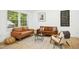 Bright living room with stylish seating arrangement, a patterned rug and natural light at 117 Bertie Dr, Raleigh, NC 27610