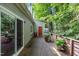 Back deck overlooking a wooded yard with a slider door and patio furniture at 119 Danforth Dr, Cary, NC 27511