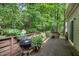 View of a deck surrounded by lush greenery, and a grill at 119 Danforth Dr, Cary, NC 27511