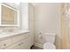 Bright bathroom featuring tile floors, a white vanity, storage cabinet, and shower with white fixtures at 119 Danforth Dr, Cary, NC 27511