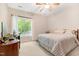 Well-lit carpeted bedroom with ceiling fan, and window view to landscaped neighborhood at 119 Danforth Dr, Cary, NC 27511