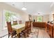 Comfortable dining area featuring a wooden table, six chairs, and a large window at 119 Danforth Dr, Cary, NC 27511
