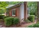 Charming brick home features red shutters, a chimney, and lovely landscaping at 119 Danforth Dr, Cary, NC 27511