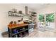 Functional kitchen space with open shelving, stainless appliances, and access to outdoor deck at 119 Danforth Dr, Cary, NC 27511