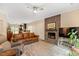 Inviting living room with a stone fireplace, plush seating, and a ceiling fan at 119 Danforth Dr, Cary, NC 27511