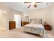 Spacious main bedroom with ensuite bathroom featuring a ceiling fan and carpeted floors at 119 Danforth Dr, Cary, NC 27511