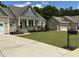 Inviting home with charming details, green lawn, and a separate garage for added space and convenience at 119 Hunterwood Pl, Benson, NC 27504