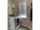 Bright laundry room featuring a side-by-side washer and dryer, with shelving and natural light at 119 Hunterwood Pl, Benson, NC 27504
