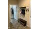 Functional mudroom with coat hooks, a bench, storage baskets, and access to a laundry room at 119 Hunterwood Pl, Benson, NC 27504