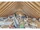 Spacious unfinished attic filled with personal belongings, showcasing ample storage potential at 1237 Shirehall Park Ln, Wake Forest, NC 27587