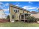 View of the home's backyard, showcasing a screened porch and lush lawn at 1237 Shirehall Park Ln, Wake Forest, NC 27587