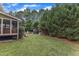 Large backyard with screened porch, deck, a play set, and mature trees offering a private setting at 1237 Shirehall Park Ln, Wake Forest, NC 27587