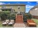 Serene backyard with a two-level deck, patio, lush lawn and established shrubbery at 1237 Shirehall Park Ln, Wake Forest, NC 27587