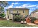 Expansive backyard with a spacious lawn, a multi-level deck, and mature landscaping at 1237 Shirehall Park Ln, Wake Forest, NC 27587