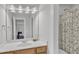 Bright bathroom with a single sink vanity, a large mirror, and a shower, creating a clean and functional space at 1237 Shirehall Park Ln, Wake Forest, NC 27587