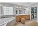 This bathroom offers a soaking tub, double vanity and a walk-in closet at 1237 Shirehall Park Ln, Wake Forest, NC 27587