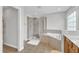 Well-lit bathroom boasts a glass-enclosed shower and a soaking tub at 1237 Shirehall Park Ln, Wake Forest, NC 27587