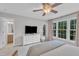 Light-filled bedroom featuring a comfortable bed, large windows, and closet access, creating a serene and inviting space at 1237 Shirehall Park Ln, Wake Forest, NC 27587