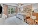 Bright bedroom with a queen-sized bed, stylish decor, large windows and an accent wall, creating a cozy retreat at 1237 Shirehall Park Ln, Wake Forest, NC 27587