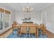 Elegant dining room featuring a large wooden table, bright chandelier, and natural light at 1237 Shirehall Park Ln, Wake Forest, NC 27587