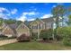 Traditional two-story home with verdant lawn, attached garage and mature trees at 1237 Shirehall Park Ln, Wake Forest, NC 27587