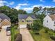 Aerial view of a two-story home with a well-manicured lawn and driveway at 1237 Shirehall Park Ln, Wake Forest, NC 27587