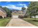 Traditional two-story home with verdant lawn, attached garage and long driveway at 1237 Shirehall Park Ln, Wake Forest, NC 27587