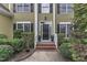 Charming front door entry with brick steps and manicured hedges at 1237 Shirehall Park Ln, Wake Forest, NC 27587