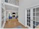 Hallway with hardwood floors leading to living room with fireplace and french doors to office at 1237 Shirehall Park Ln, Wake Forest, NC 27587