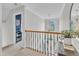 Upstairs hallway featuring natural light, a chandelier, and an open feel at 1237 Shirehall Park Ln, Wake Forest, NC 27587