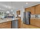 Bright kitchen view with stainless steel appliances, granite countertops, and wood cabinetry at 1237 Shirehall Park Ln, Wake Forest, NC 27587