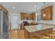 Well-lit kitchen with wood cabinets, stainless steel appliances, granite counters, and breakfast bar seating at 1237 Shirehall Park Ln, Wake Forest, NC 27587